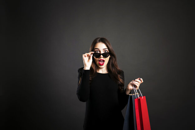 Happy brunette female with long hair in casual outfit posing over isolated white background.