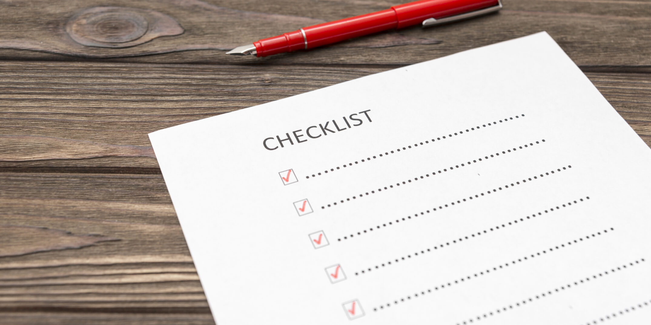 checklist, pen fountain pen, sheet of paper on a wooden background. scroll.