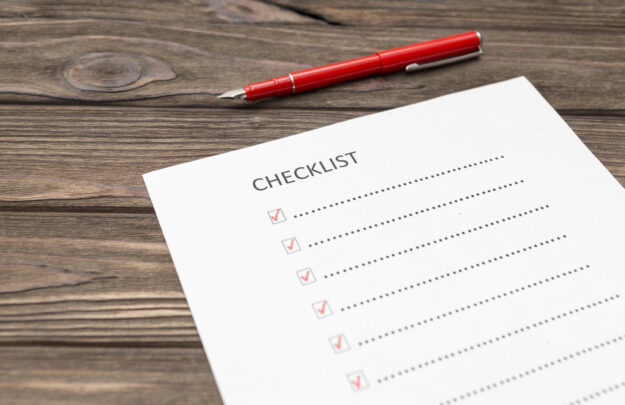 checklist, pen fountain pen, sheet of paper on a wooden background. scroll.