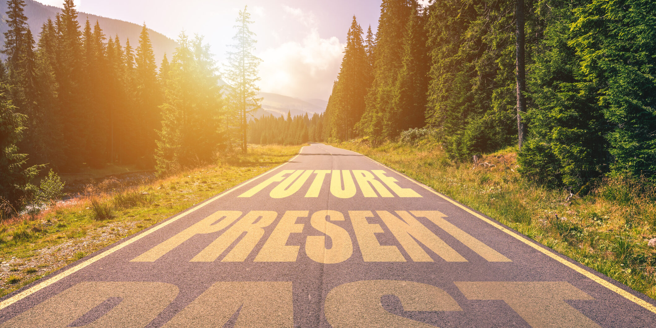 Past, Present, Future concept. Driving on an empty road in the mountains to the Future passing Present and leaving behind the Past.