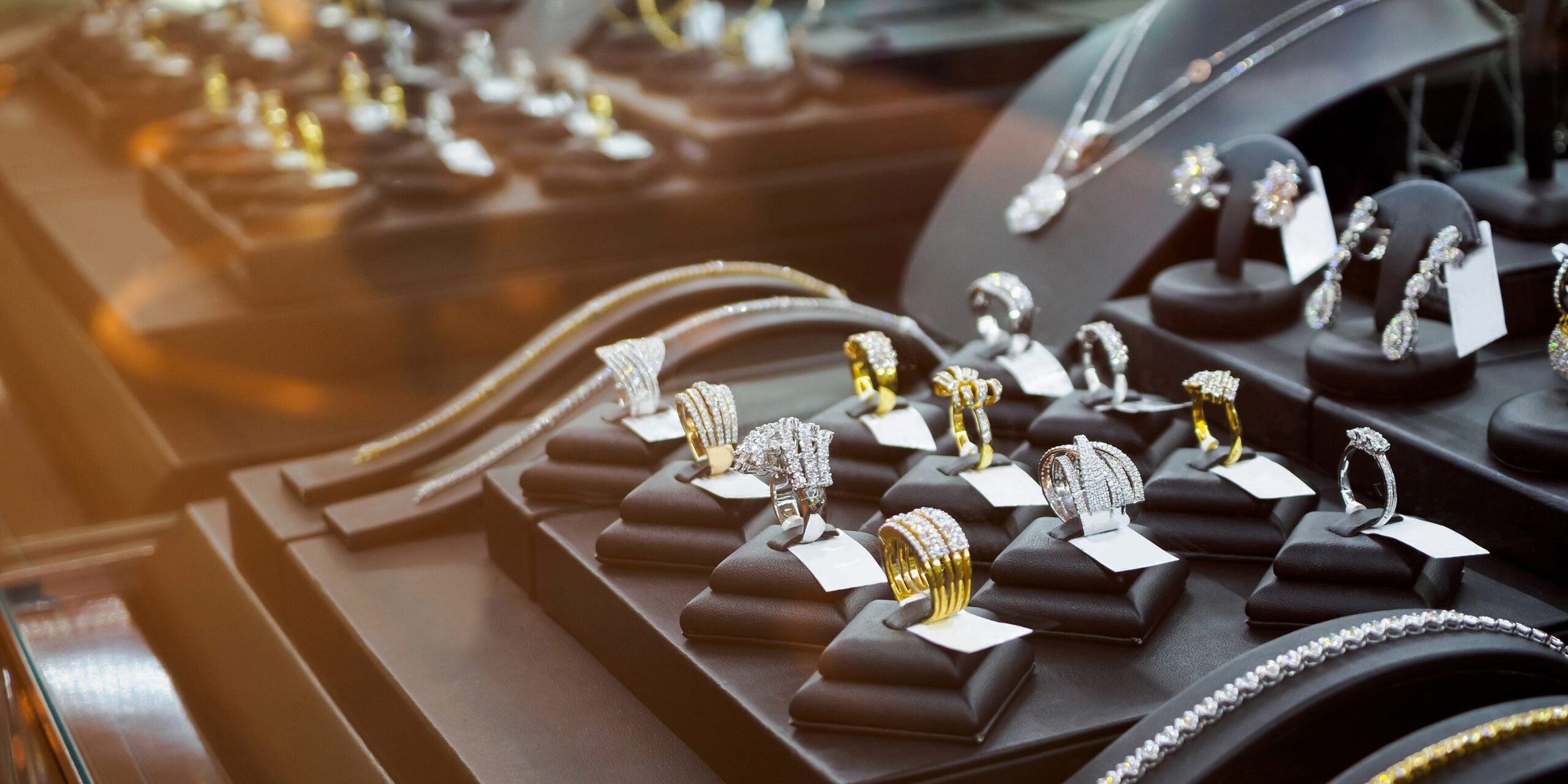 Gold jewelry diamond shop with rings and necklaces luxury retail store window display showcase